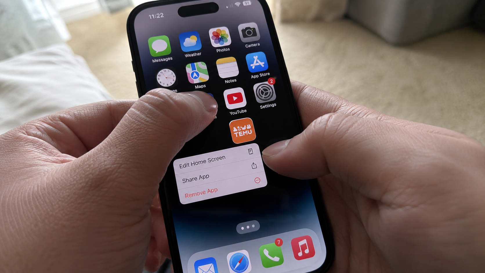 how to stop impulse buying - close-up of hands deleting a shopping app from phone home screen