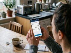 Pay Yourself First: How Much to Save, Where to Put It, and 4 Priority Steps woman setting up automatic savings transfer on phone at kitchen table